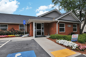 Atlanta apartment for rent - Brick building with large windows and walkway leading to entrance of the leasing office.