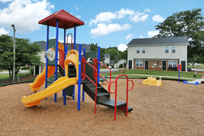 Atlanta apartment for rent - a playground with a yellow and red slide and monkey bars