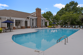 Morrisville apartment for rent - A pool with a brick building behind it.