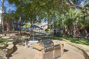 San Antonio apartment for rent - A backyard with a BBQ grill and patio furniture.
