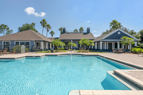 Fort Myers apartment for rent - resort style pool with palm trees and lounge seating