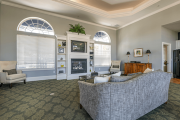 Fort Myers apartment for rent - A living room with a grey couch and a fireplace.