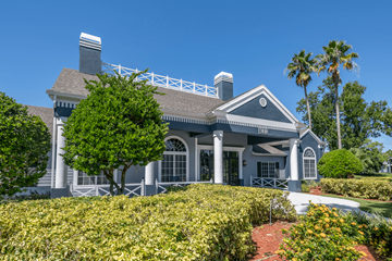 Fort Myers apartment for rent - A house with a grey and white exterior and a large front porch.
