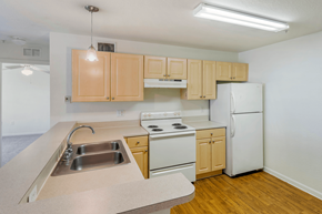 St Petersburg apartment for rent - a kitchen with white appliances and wooden cabinets