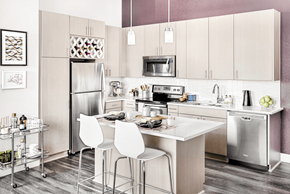 Denver apartment for rent - A modern kitchen with a white table and chairs.