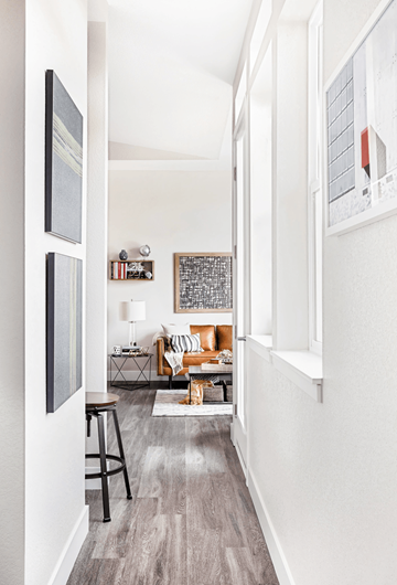 Denver apartment for rent - A living room with a couch, a chair, a table, and a painting on the wall.