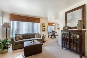 Mesa apartment for rent - Carpeted Model Living Room with Couch, Ottoman and Buffett Cabinet Under Mirror