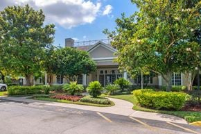 Sanford apartment for rent - Parking Lot and Walkway in Front of Leasing Office Surrounded by Shrubs