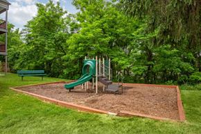 Montgomery Village apartment for rent - Green and Yellow Playground Near Treeline in Courtyard