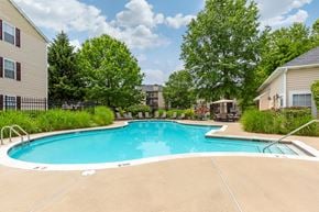 Gaithersburg apartment for rent - Swimming Pool with sundeck and lounge chairs surrounded by green landscaping and building exteriors