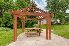Gaithersburg apartment for rent - Wood gazebo with picnic table next to walkway surrounded by green grass and mature trees