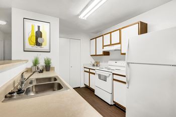 Kitchen with double sink and overhead cabinets