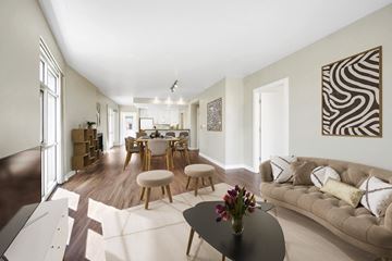 Denver apartment for rent - A living room with a couch, coffee table, and a painting on the wall.