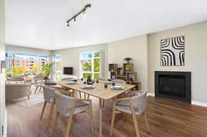 Denver apartment for rent - A dining room with a table set for six with a fireplace and a zebra print picture on the wall.