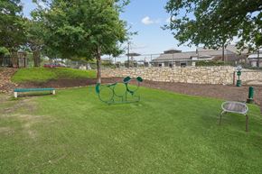 Austin apartment for rent - A park with a green lawn and a playground.