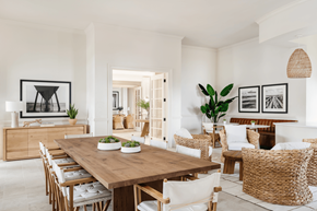 Orlando apartment for rent - a white dining room with a wooden table and rattan chairs