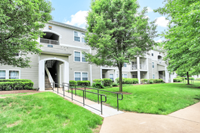 Warrenton apartment for rent - A building with a balcony and a tree in front of it.