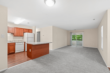 Waldorf apartment for rent - A spacious kitchen with wooden cabinets and a white refrigerator.