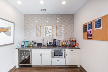 Macon apartment for rent - A kitchen with white cabinets and a black countertop.
