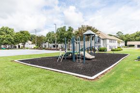 Macon apartment for rent - A playground with a slide and a green roofed structure.