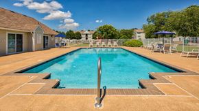 Hampton apartment for rent - Swimming Pool and Sun Deck with Lounge Chairs with Trees and Building Exteriors in the Background