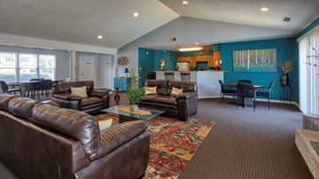 Hampton apartment for rent - A living room with brown leather couches and a rug.