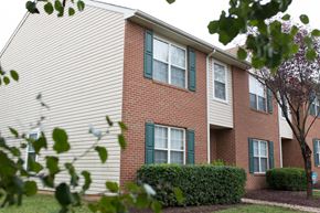 Stafford apartment for rent - exterior of apartment building with trees and bushes