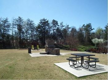 A picnic table is surrounded by a white square with a black border.