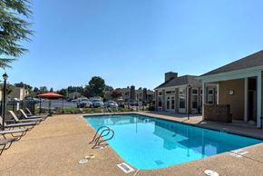 High Point apartment for rent - A pool with a blue tiled edge and a white pool marker at Fox Hollow Apartment Homes, High Point, North Carolina