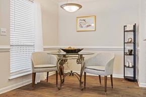Greensboro apartment for rent - A dining room with a table and two chairs. at Woodland Park Apartment Homes, Greensboro, NC, 27455