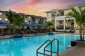Key West apartment for rent - a swimming pool at sunset at an apartment complex