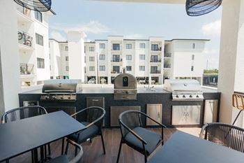 Outdoor pavilion with tv's, summer kitchen, pizza oven, and outdoor games