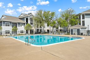 Austin apartment for rent - A swimming pool in front of apartment buildings.