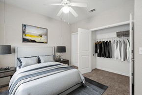 Austin apartment for rent - A bedroom with a large bed and a painting on the wall.