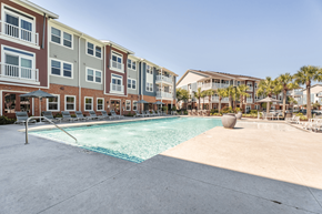 Savannah apartment for rent - A swimming pool in front of apartment buildings.