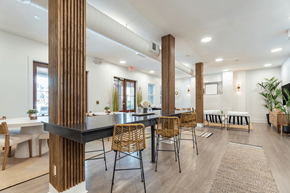 Savannah apartment for rent - A modern dining room with a long table and chairs.