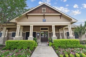 Denton apartment for rent - A building with a brown roof and a sign that says