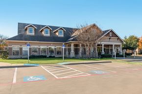 Denton apartment for rent - A building with a parking lot in front of it.
