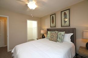St. Augustine apartment for rent - The Bedroom is a comfortable space with a large bed centered on the main wall. A large walk-in closet sits on the side of the room. The carpeted flooring continues throughout with furniture filling spaces around the room.