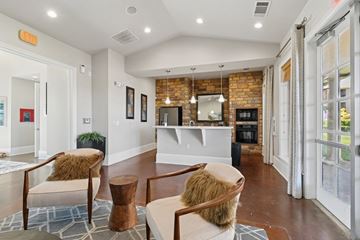 Fort Worth apartment for rent - A living room with a brown chair and a brown ottoman.