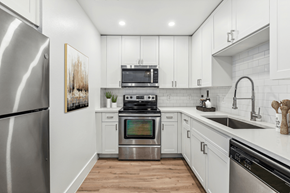 South Miami apartment for rent - a white kitchen with stainless steel appliances and white cabinets