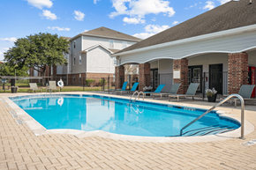Houston apartment for rent - a swimming pool in front of a house