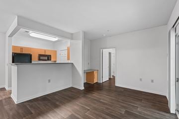 Waldorf apartment for rent - A living room with a television and a bar area.