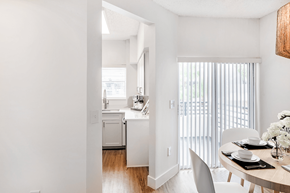 Dania Beach apartment for rent - a dining area with a table and chairs and a kitchen in the background