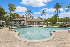 Deerfield Beach apartment for rent - a large swimming pool with palm trees in the background