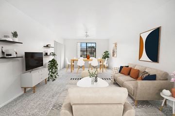 Phoenix apartment for rent - A living room with a grey carpet and a large painting on the wall.