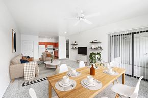 Phoenix apartment for rent - Open concept dining and living area with wood table at ReNue Downtown Apartments, Phoenix, AZ 85007