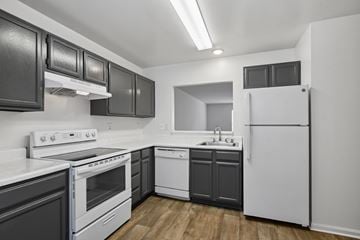 Stafford apartment for rent - A kitchen with black cabinets and white appliances.