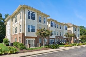 Waldorf apartment for rent - A row of townhouses with a sidewalk and greenery in front.