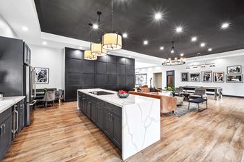 Open floor plan kitchen with marble waterfall island